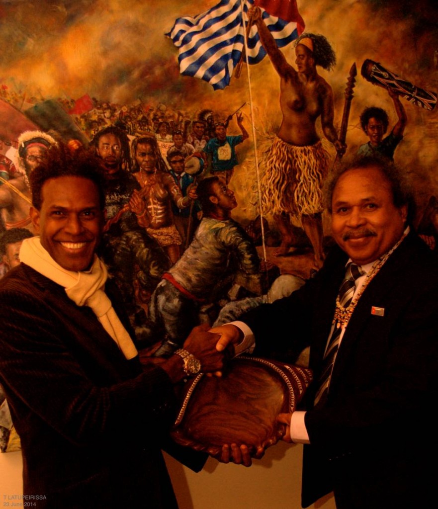 Foreign Affairs Minister Jacob Rumbiak, with Matt Gale (Solomon Islands Association in Victoria) in front of 'Liberty Papua leading the people (after Delacroix)' by Peter Woods 2011 